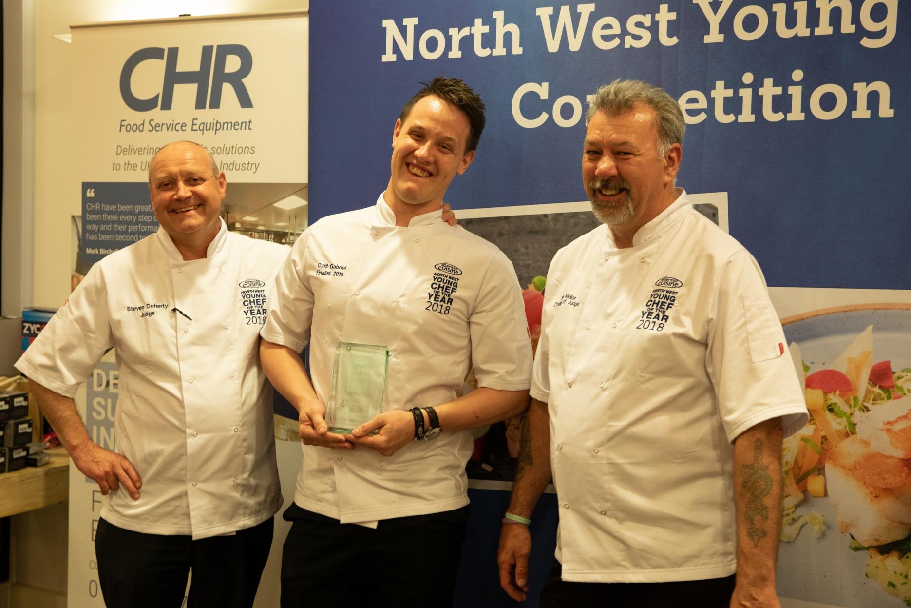 (L-R) Judge Steven Doherty with winner Cyril Gabriel, and judge Brian Mellor