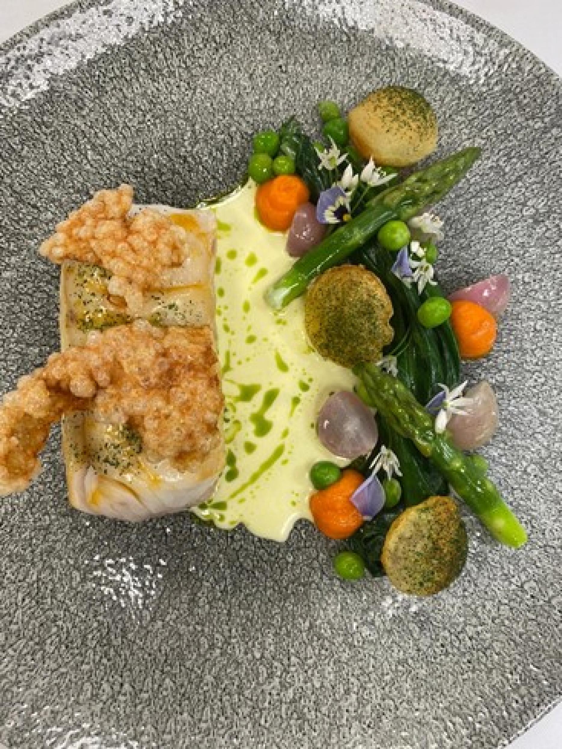 Charlie’s dish is a cod poached in lobster butter, lobster tapioca crisp, seasonal vegetables, pomme souffles, carrot puree and split butter sauce. Charlie’s dish is a cod poached in lobster butter, lobster tapioca crisp, seasonal vegetables, pomme souffles, carrot puree and split butter sauce.
