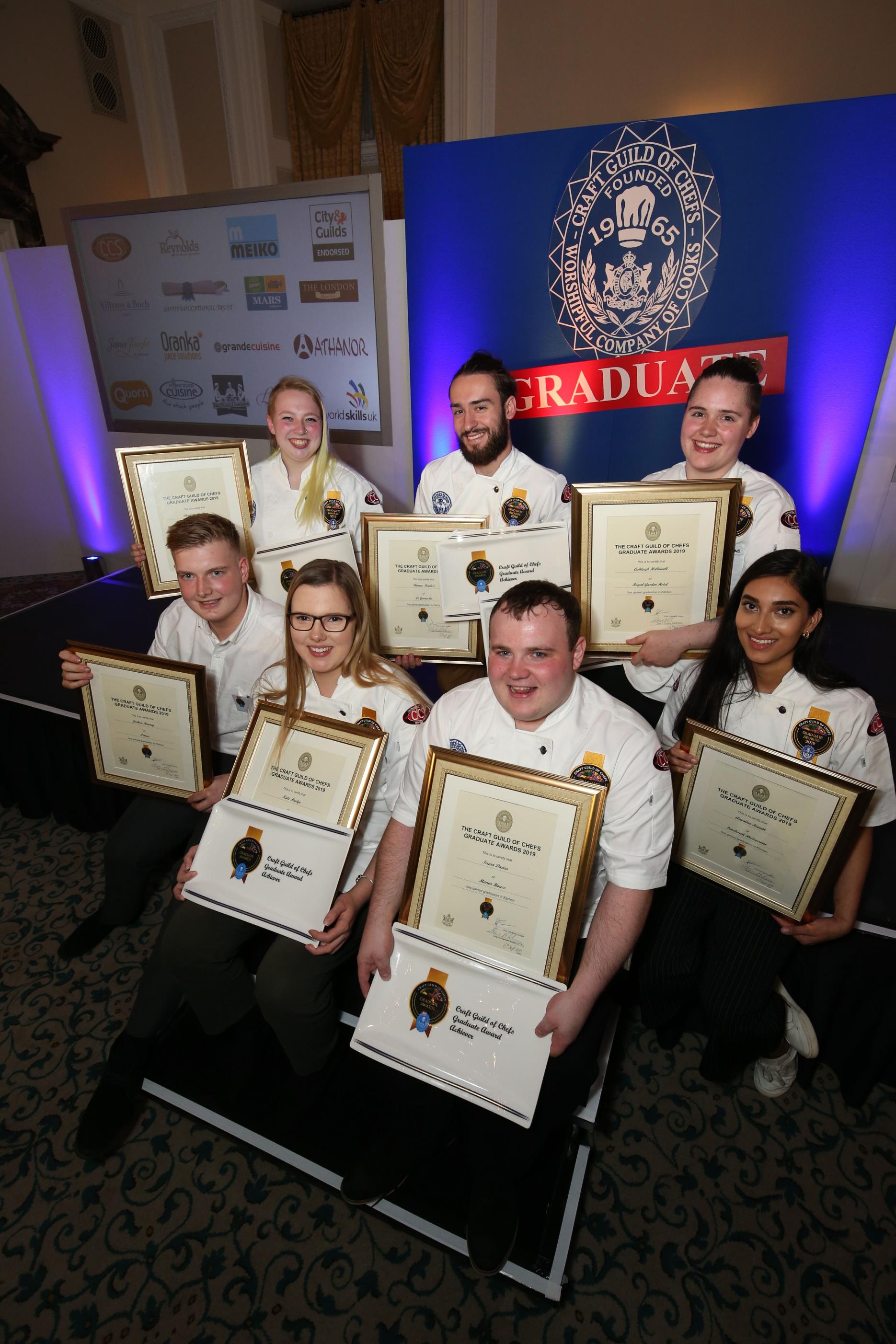 Seven young graduates celebrating reaching the Graduate Awards hall of fame Craft Guild of Chefs final competition chefs culinary